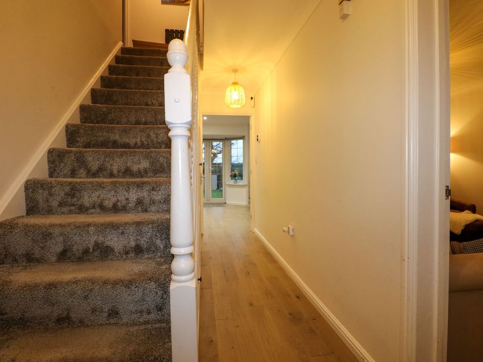 A hallway with stairs and light fixture at Number 5 in 