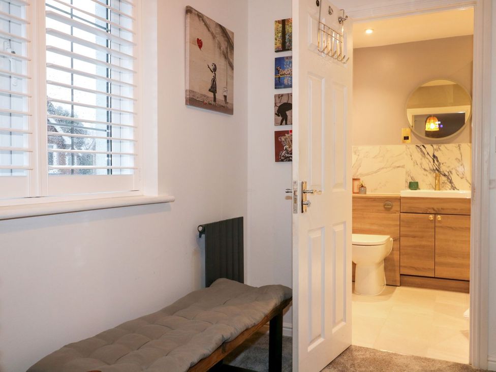 A bathroom with a sink and toilet visible from the entrance at Number 5 