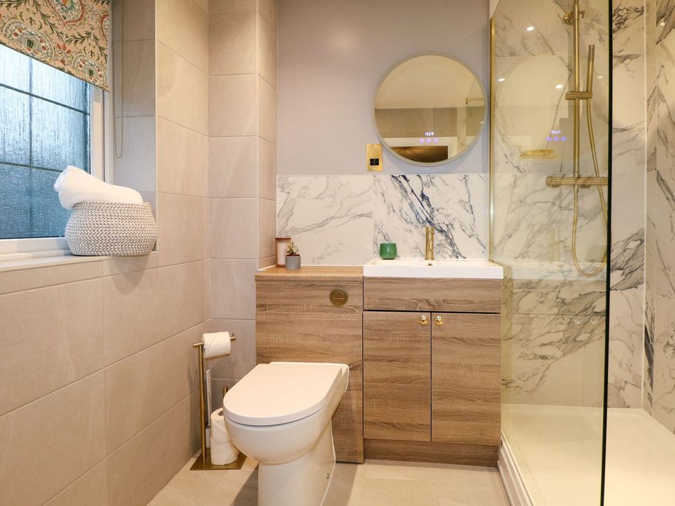 A bathroom featuring a shower and sink at Number 5