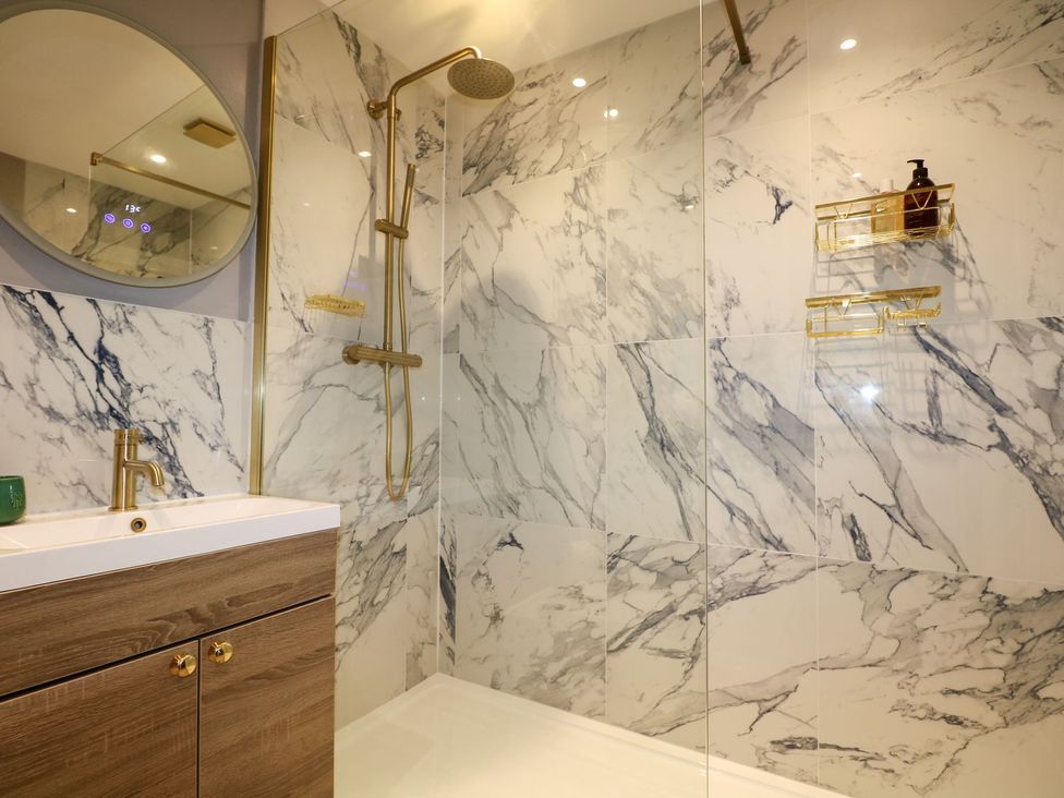 A bathroom with a shower and a sink at Number 5