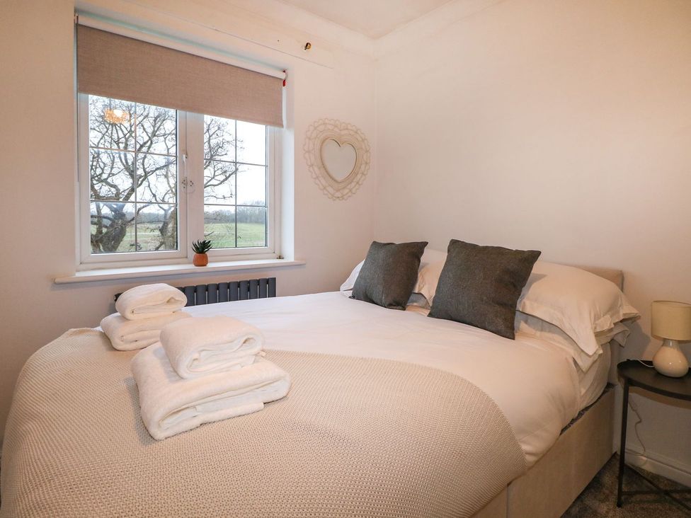 A bedroom with a bed and window at Number 5