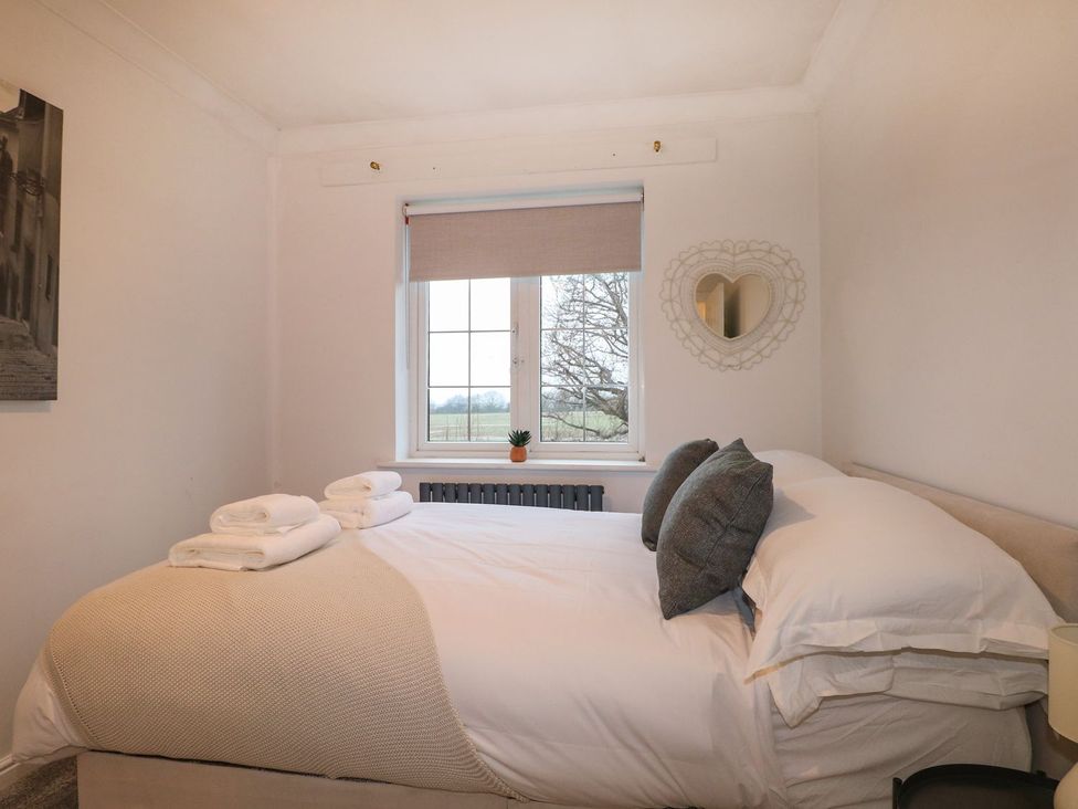 A bedroom with a bed and window at Number 5