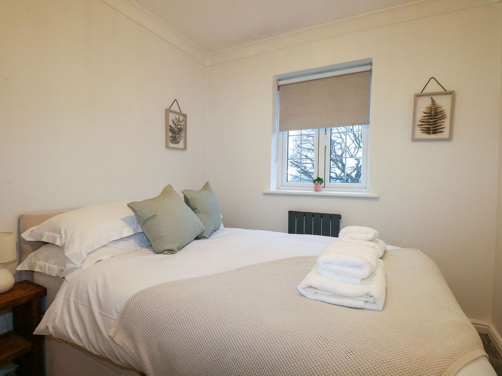 A bedroom with a bed and wall art at Number 5