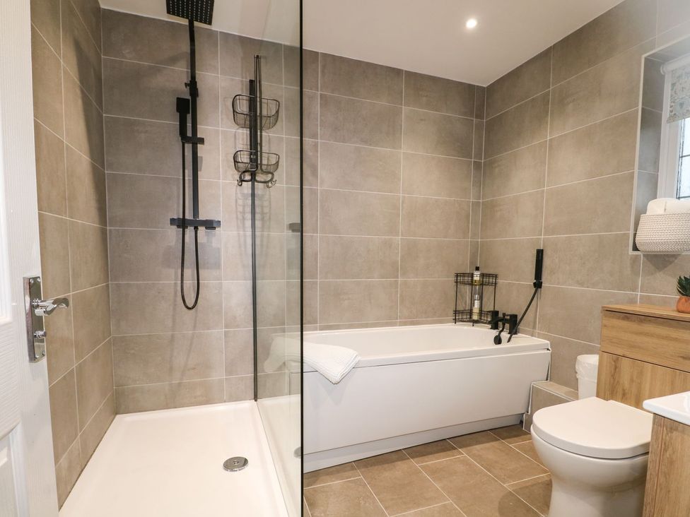 A bathroom with a shower and bathtub at Number 5