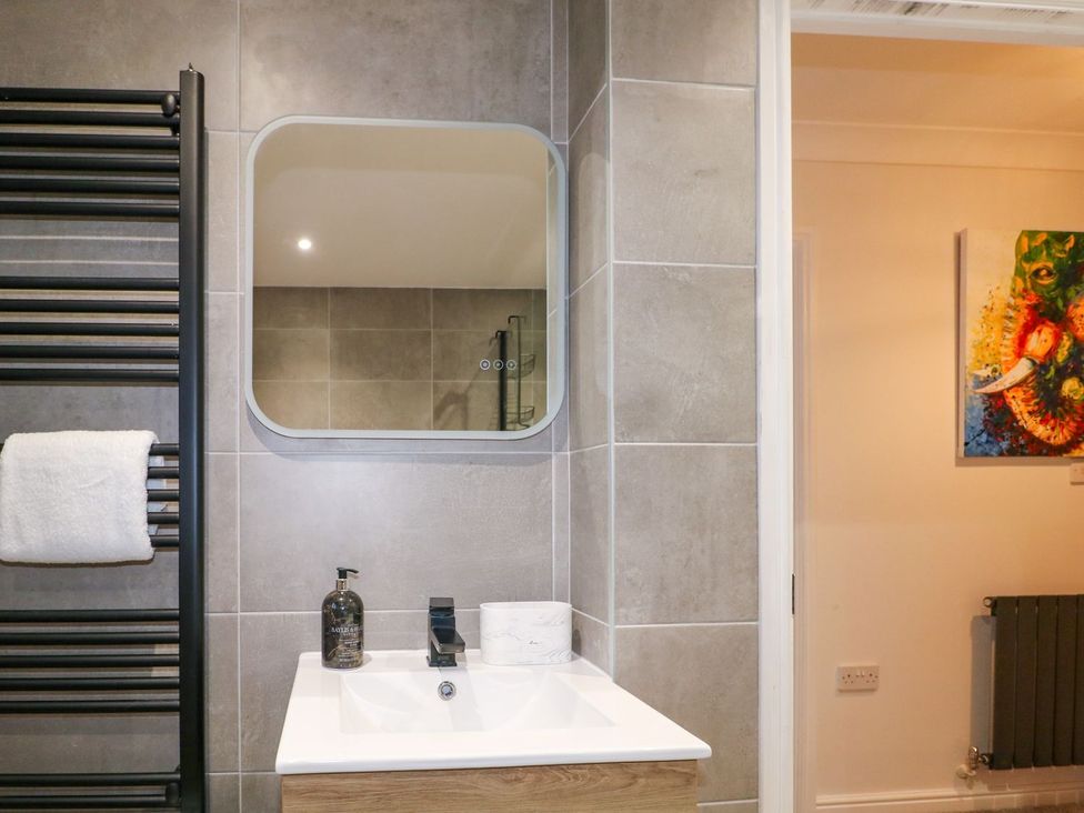 A bathroom with a sink and a mirror at Number 5