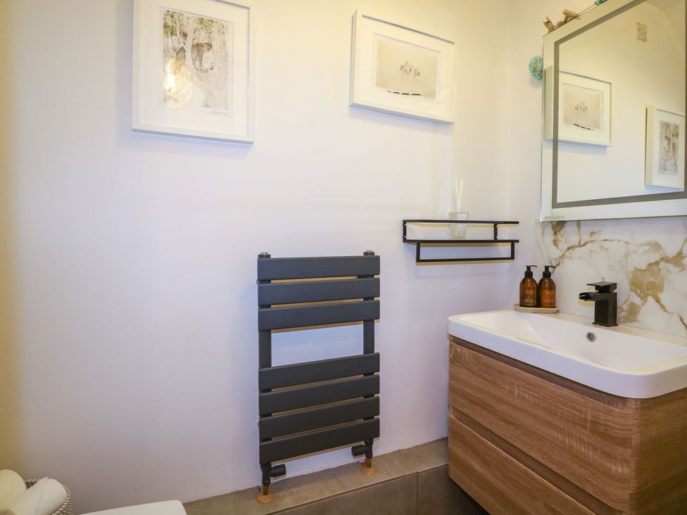 A bathroom with a sink and mirror at Number 5