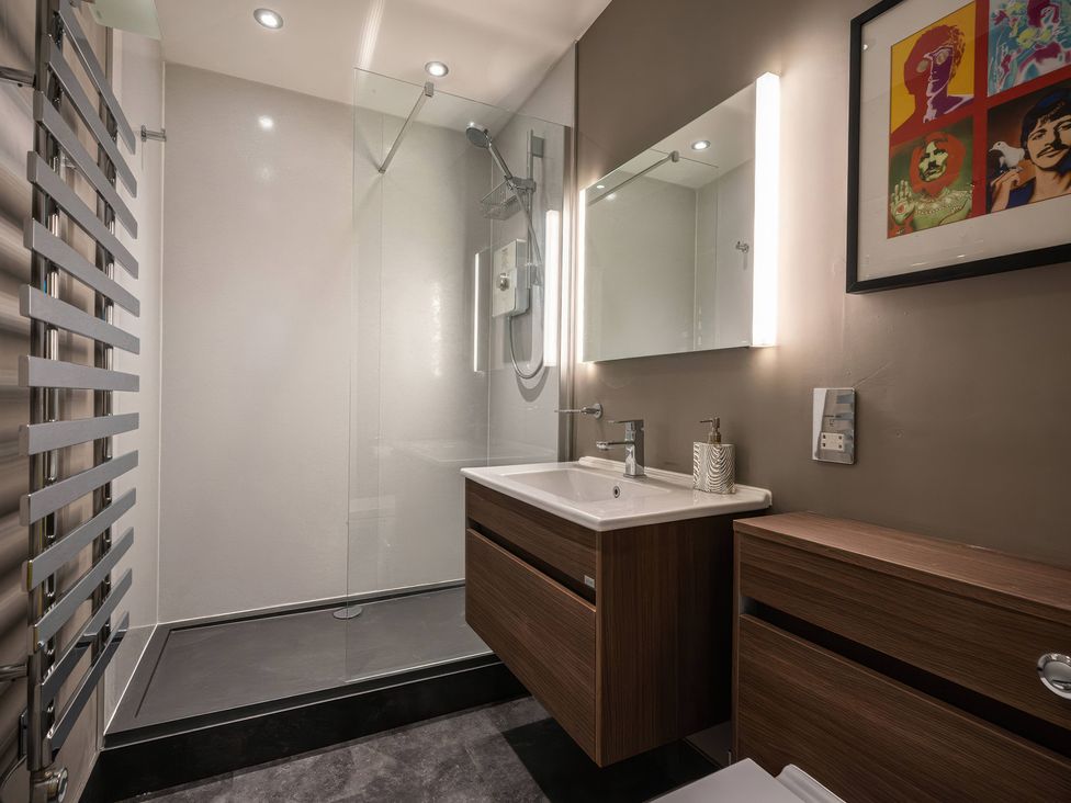 A bathroom with a shower, sink, and toilet at The Luxury Shed in Huddersfield
