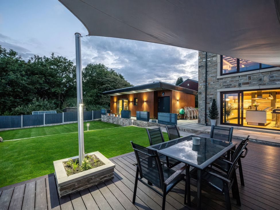 An outdoor dining area with a table and chairs at The Luxury Shed in Huddersfield