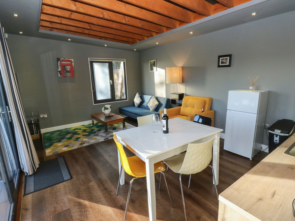 A living room with furniture including a sofa and a table at The Luxury Shed in Huddersfield