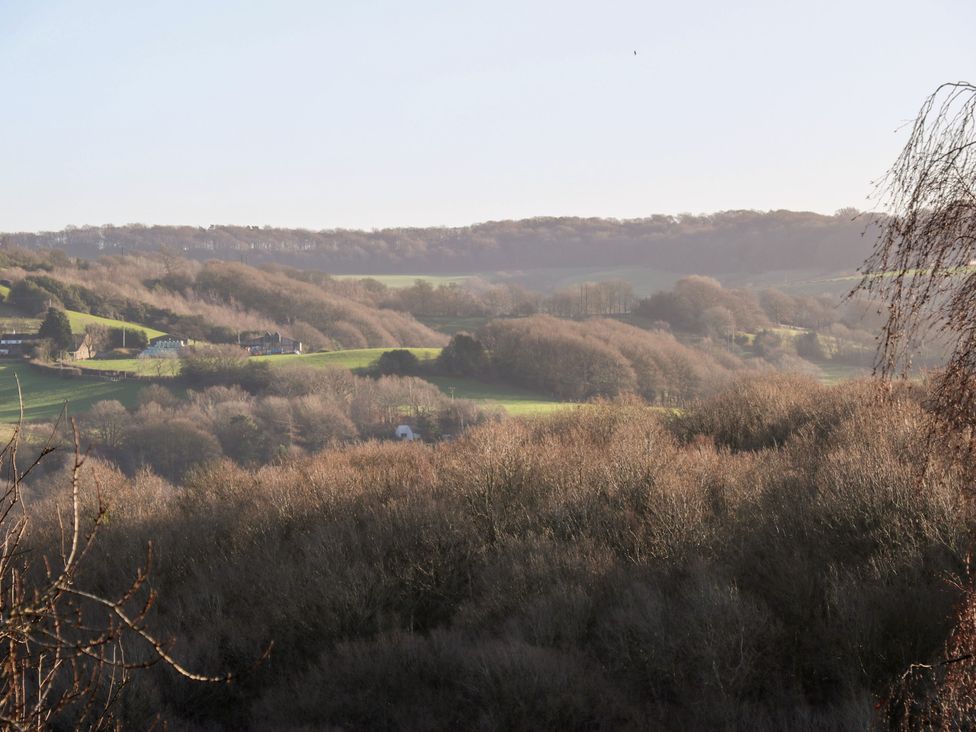 A view of hills and trees with buildings in the landscape at The Luxury Shed in Huddersfield
