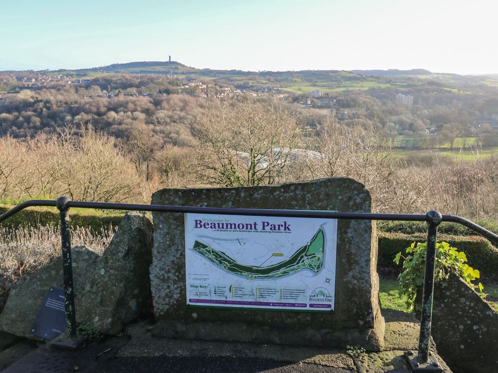 A park map sign at Beaumont Park with a view of the landscape in Huddersfield