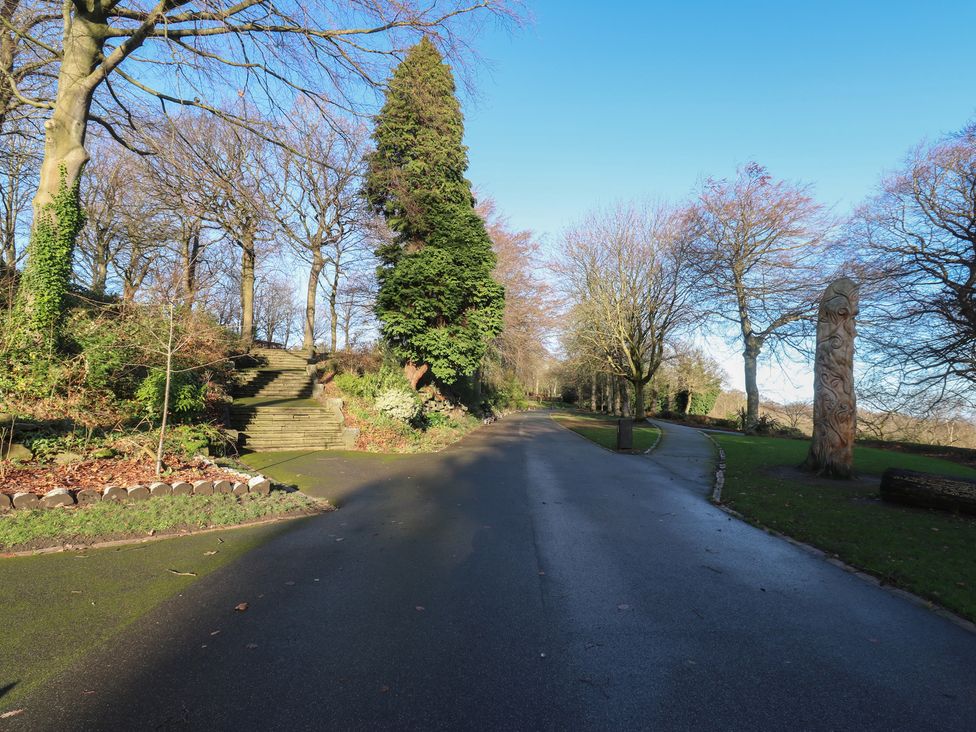 A road with trees and a sculpture at The Luxury Shed in Huddersfield