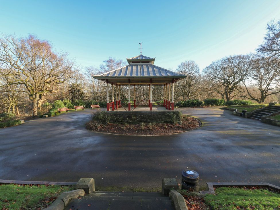 A bandstand in a park with pathways and benches at The Luxury Shed in Huddersfield