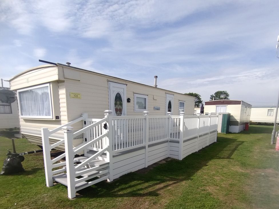 A mobile home with steps and railing at Whispering Meadows - 104 Great Yarmouth