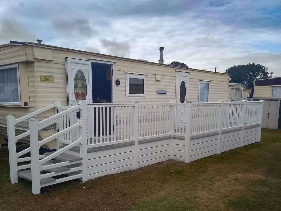 A mobile home with white railing and steps at Whispering Meadows - 104 Great Yarmouth