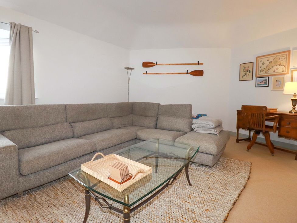 A living room with a sectional sofa and a coffee table at Cribba