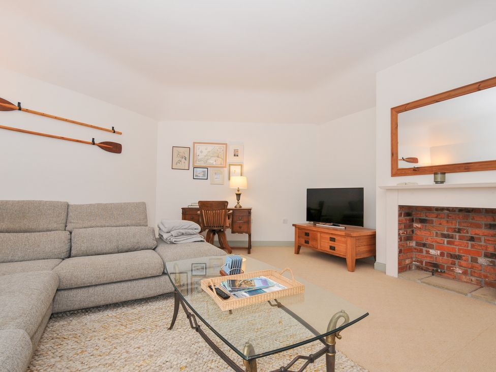A living room with a sofa and a table at Cribba Port Isaac