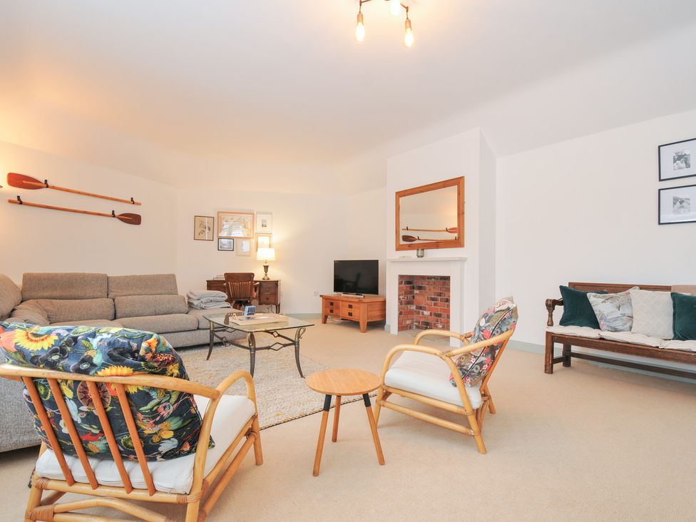 A living room with a sofa and TV at Cribba in Port Isaac