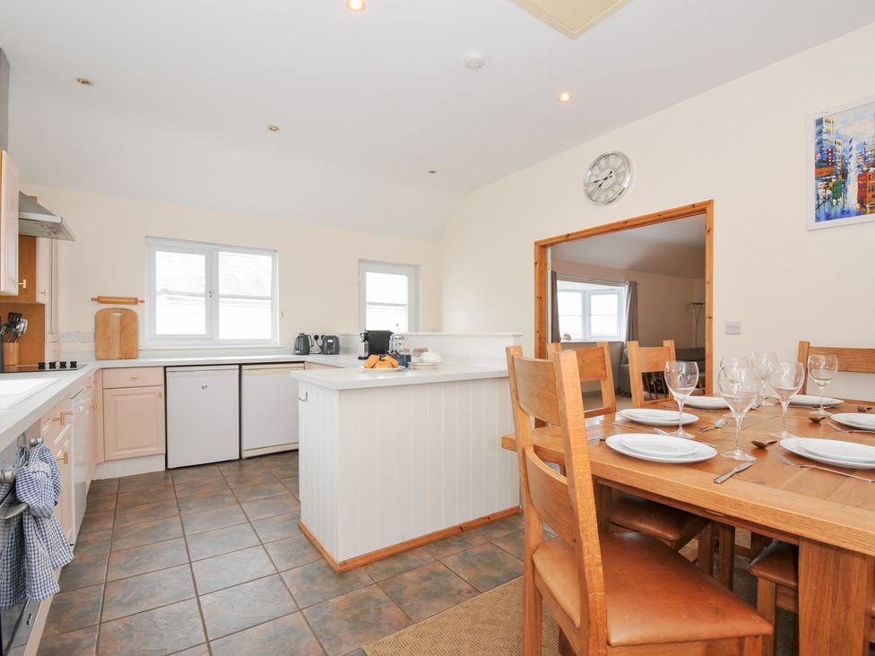 A kitchen with a dining table at Cribba in Port Isaac