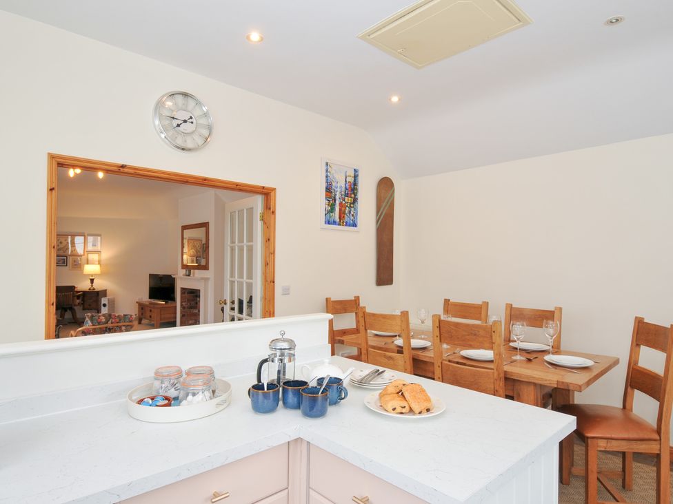 A kitchen with a table and chairs at Cribba Port Isaac