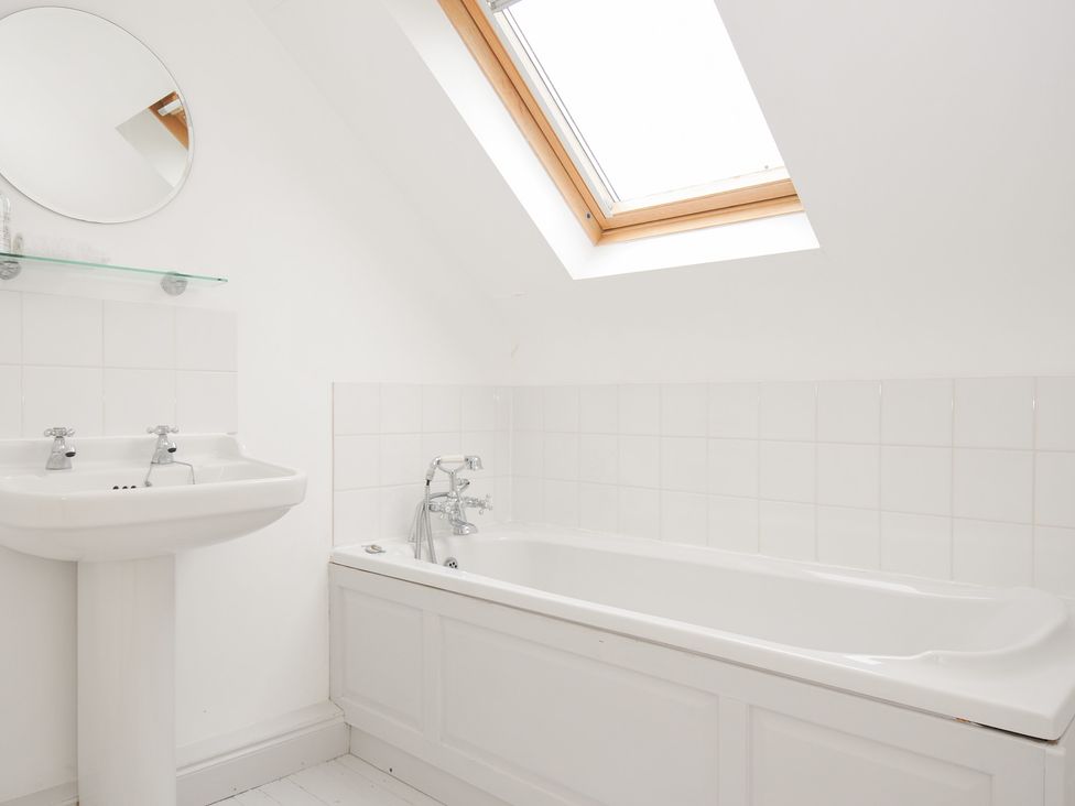 A bathroom with a wash basin and bathtub at Cribba in Port Isaac