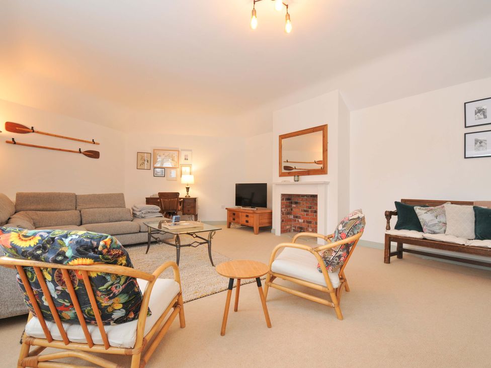 A living room with a sofa and chairs at Cribba in Port Isaac