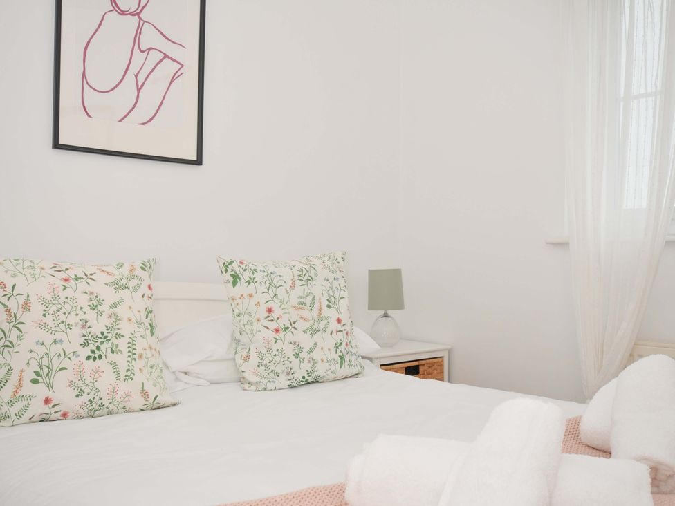 A bedroom with pillows and a lamp at Cribba in Port Isaac