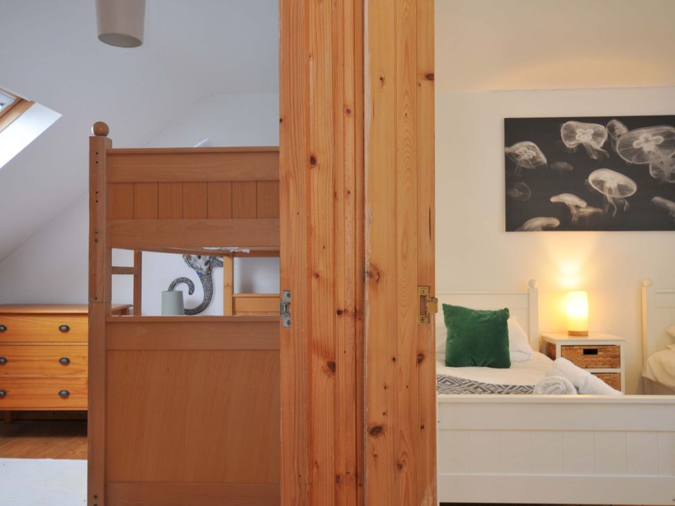 A bedroom with a bunk bed and a dresser at Cribba in Port Isaac
