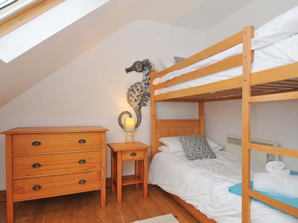 A bedroom with a bunk bed and a chest of drawers at Cribba in Port Isaac