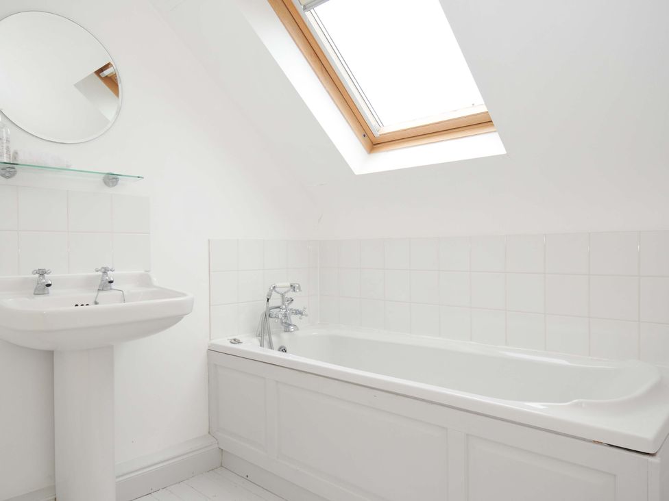 A bathroom with a bathtub and sink at Cribba in Port Isaac