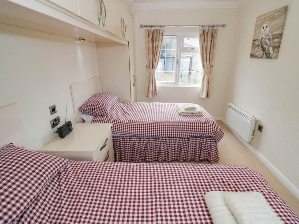 A bedroom with two beds and a window at Cabin In The Woods Silverstone