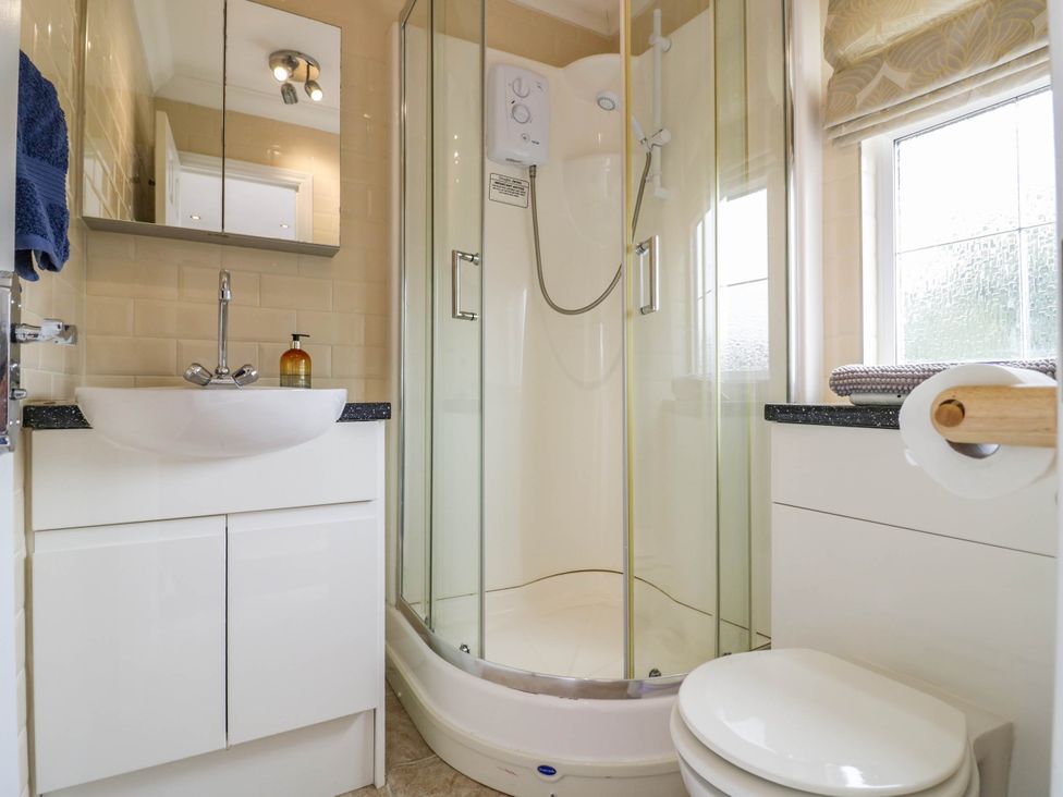 A bathroom with a sink shower and toilet at Cabin In The Woods Silverstone
