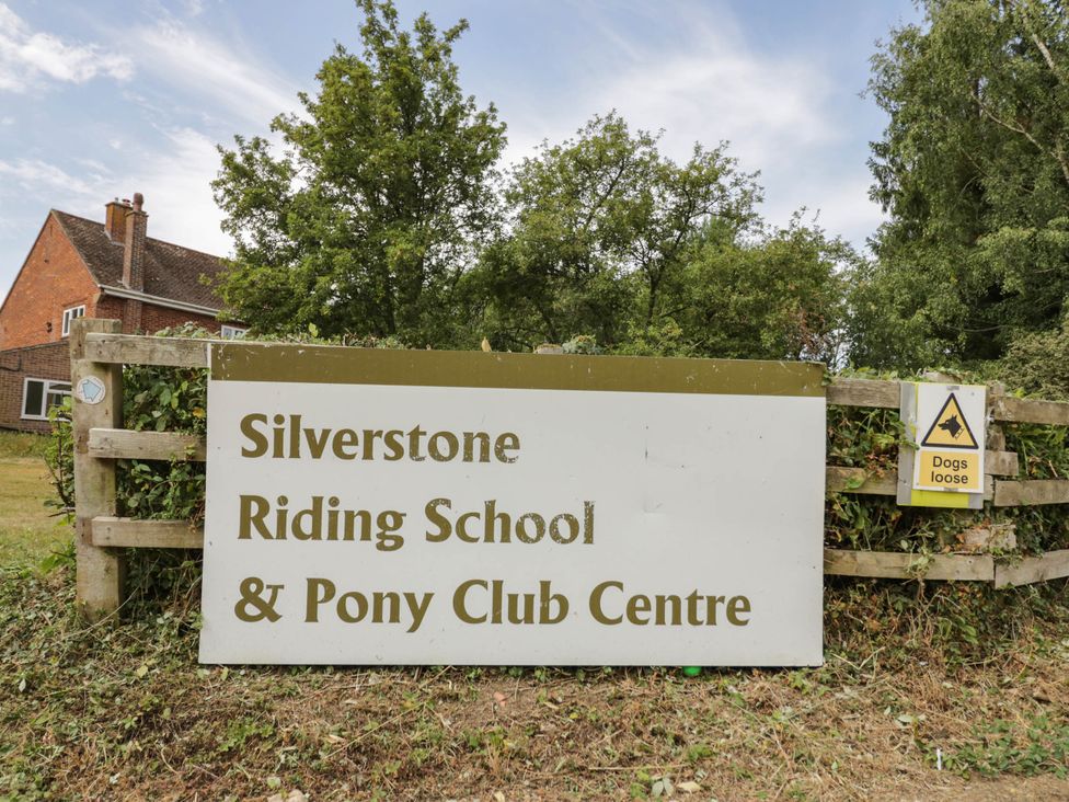 A sign for Silverstone Riding School and Pony Club Centre outdoors in Silverstone