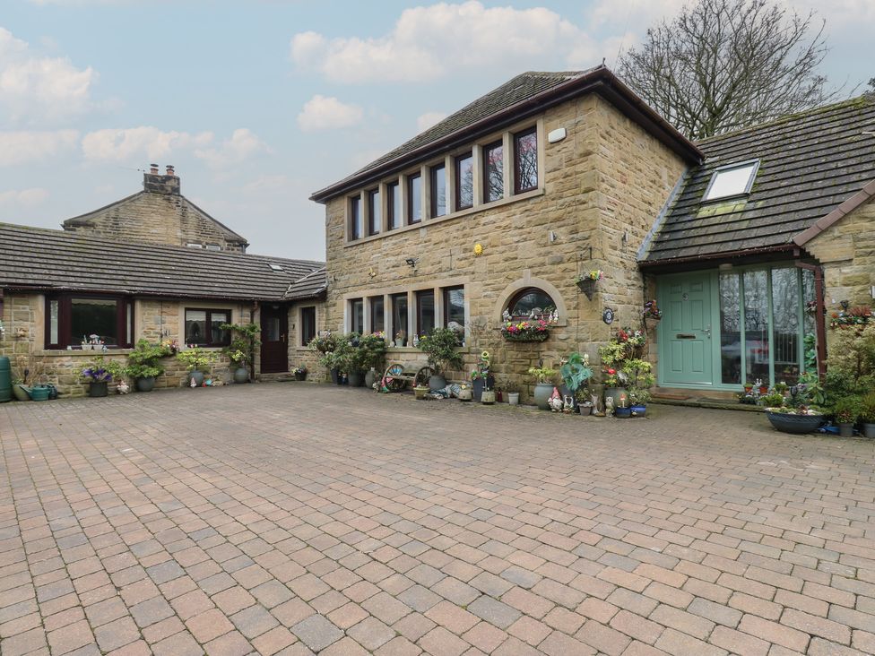 A house exterior with planters and a paved area at The Annex at Ryefield Lodge
