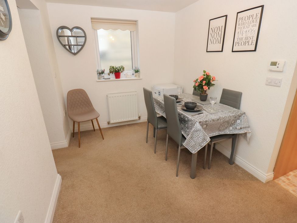 A dining room with table and chairs at The Annex at Ryefield Lodge