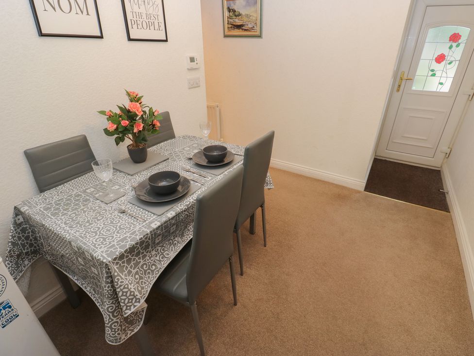 A dining room with a table and chairs at The Annex at Ryefield Lodge