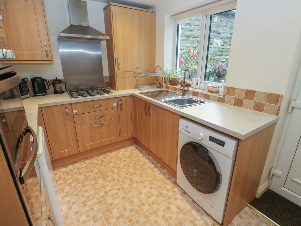A kitchen with cabinets and appliances at The Annex at Ryefield Lodge