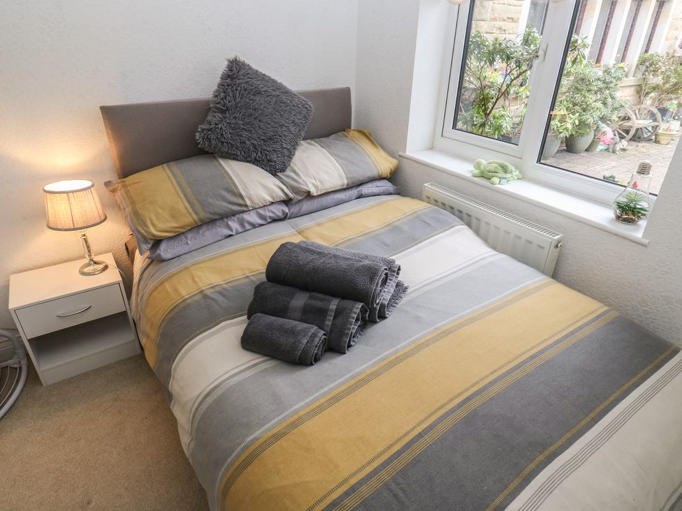 A bedroom with a bed and window at The Annex at Ryefield Lodge