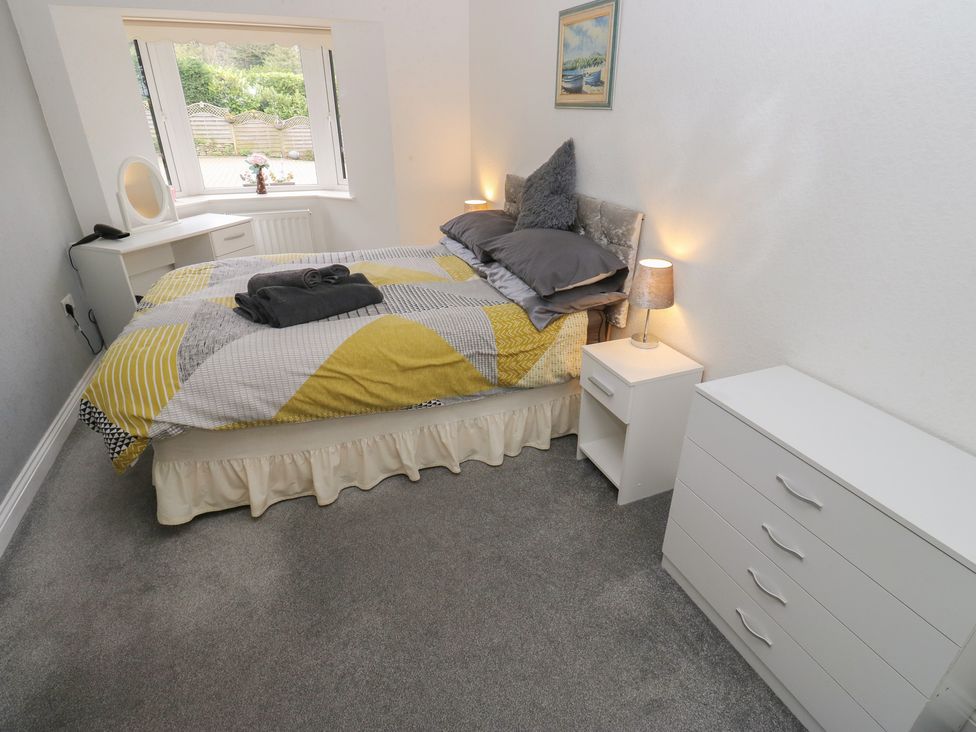 A bedroom with a bed and nightstand at The Annex at Ryefield Lodge