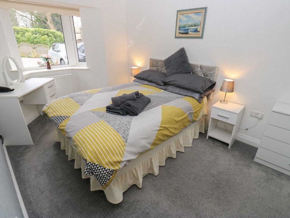 A bedroom with a bed and desk at The Annex at Ryefield Lodge