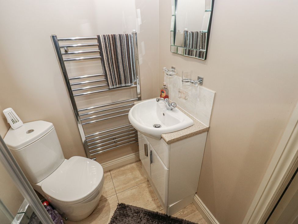 A bathroom with a sink, toilet, and towel rail at The Annex at Ryefield Lodge
