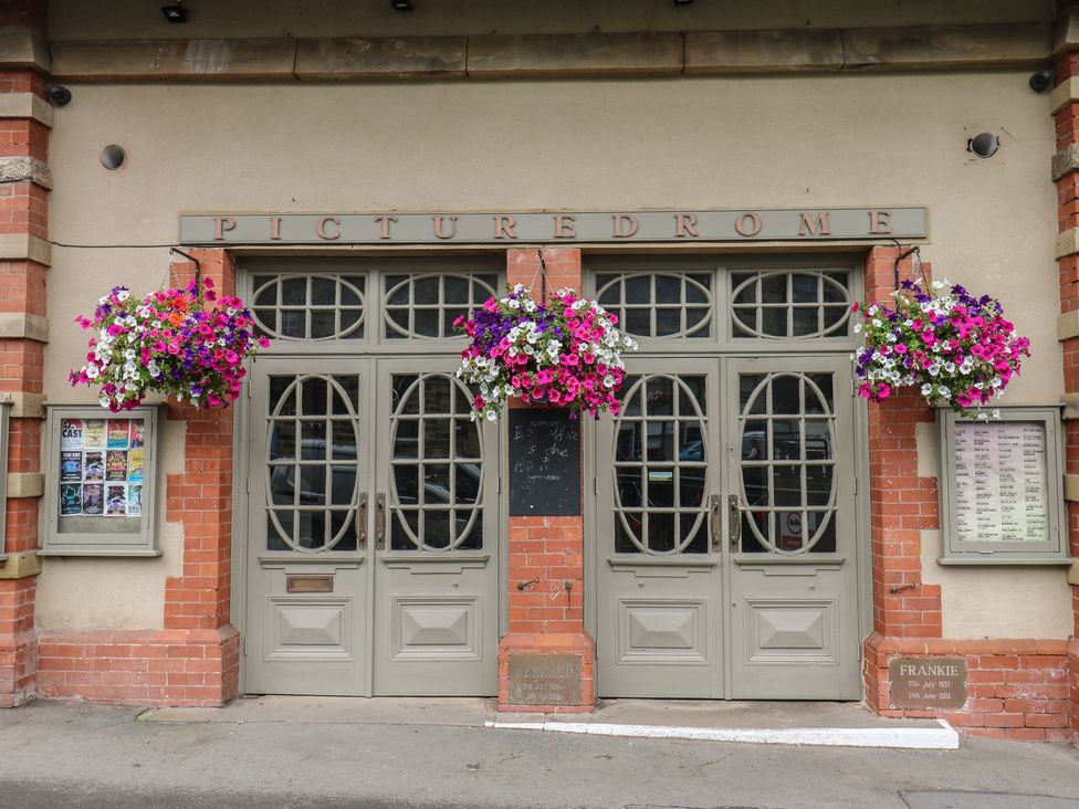 An exterior of the Picturedrome building with hanging flowers at The Annex at Ryefield Lodge