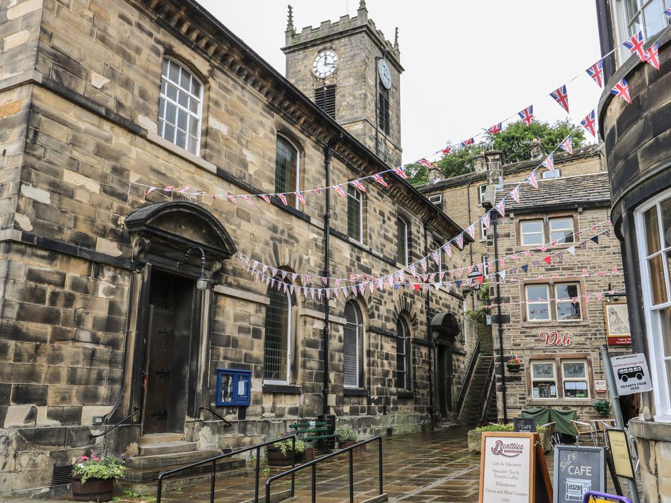 An outdoor alley with a clock tower and shops at The Annex at Ryefield Lodge 