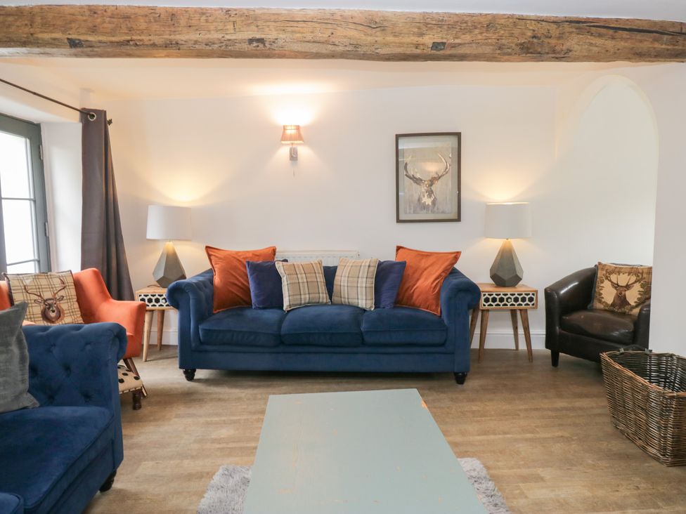 A living room with a blue sofa and a coffee table at No.2 The Flags in Grange-over-Sands