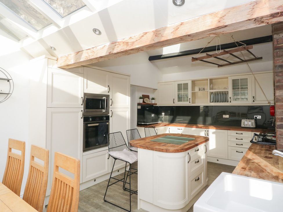 A kitchen with appliances and dining area at No.2 The Flags, Grange-over-Sands