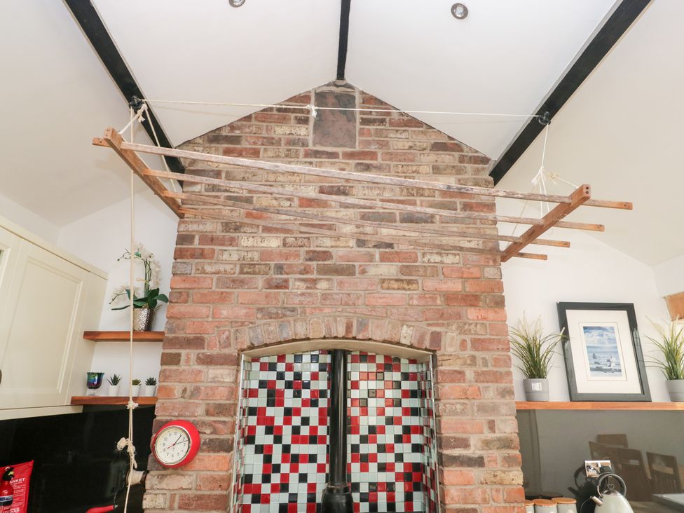 A kitchen with a brick wall and a drying rack at No.2 The Flags, Grange-over-Sands