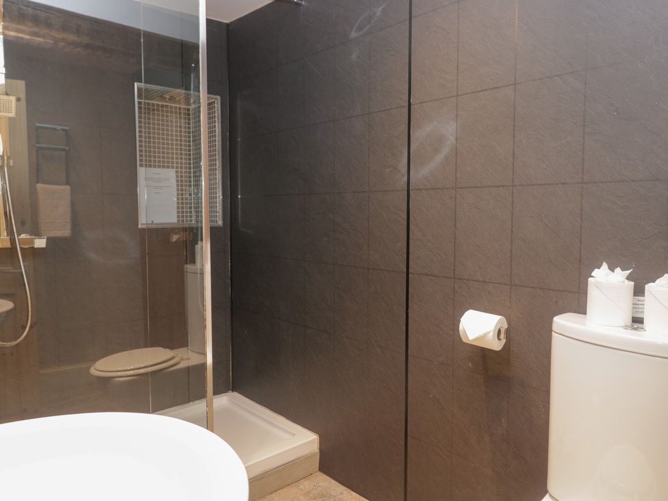 A bathroom with shower toilet and washbasin at No.2 The Flags in Grange-over-Sands