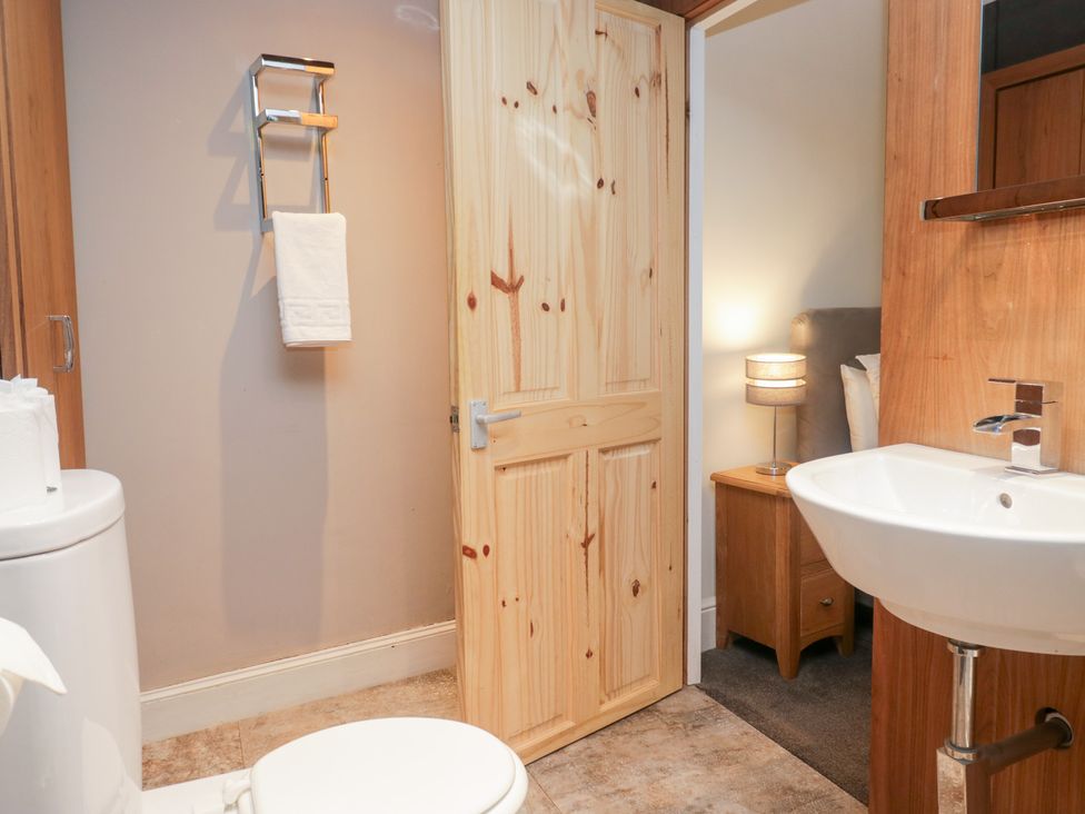 A bathroom featuring a sink and toilet at No.2 The Flags in Grange-over-Sands