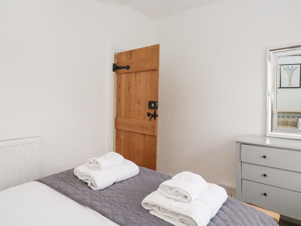 A bedroom with towels on the bed at No.2 The Flags, Grange-over-Sands