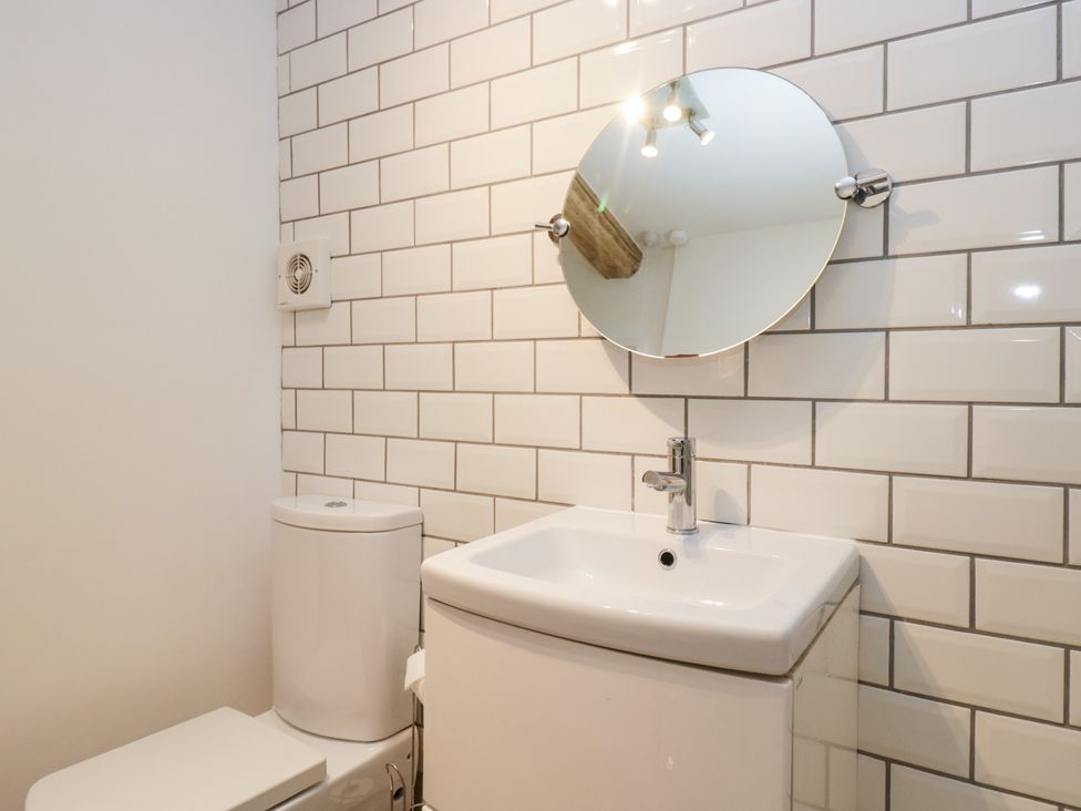 A bathroom with a toilet and sink at No.2 The Flags, Grange-over-Sands